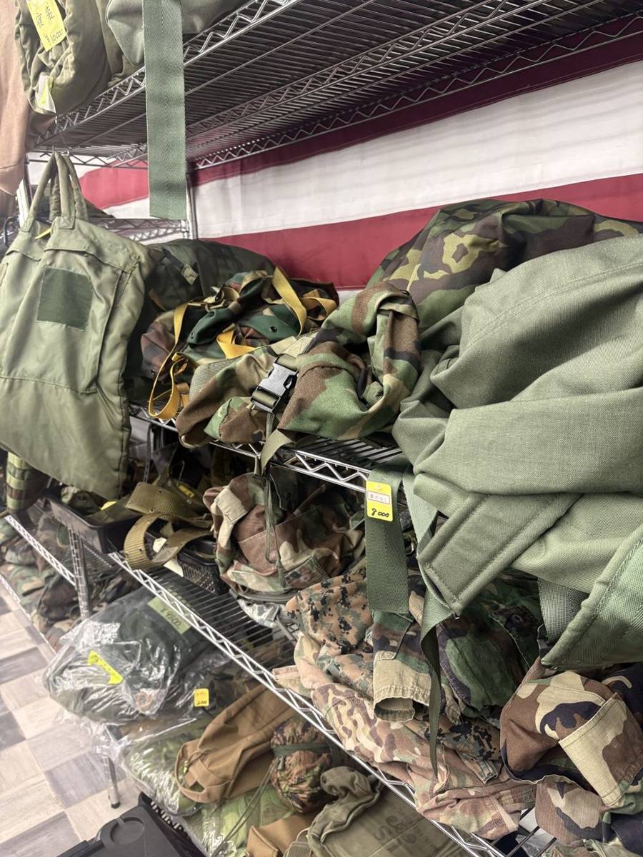 星条旗の前に迷彩の装備が並ぶ米軍払下げ品の売場
